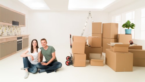 Professional movers handling household furniture carefully