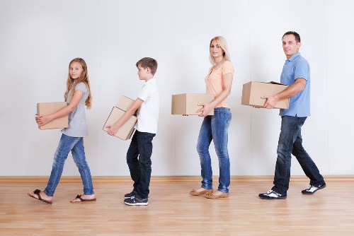 Packed moving boxes and furniture ready for transport in Coulsdon